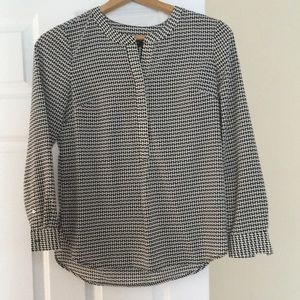 Ladies long sleeve black and white patterned shirt.